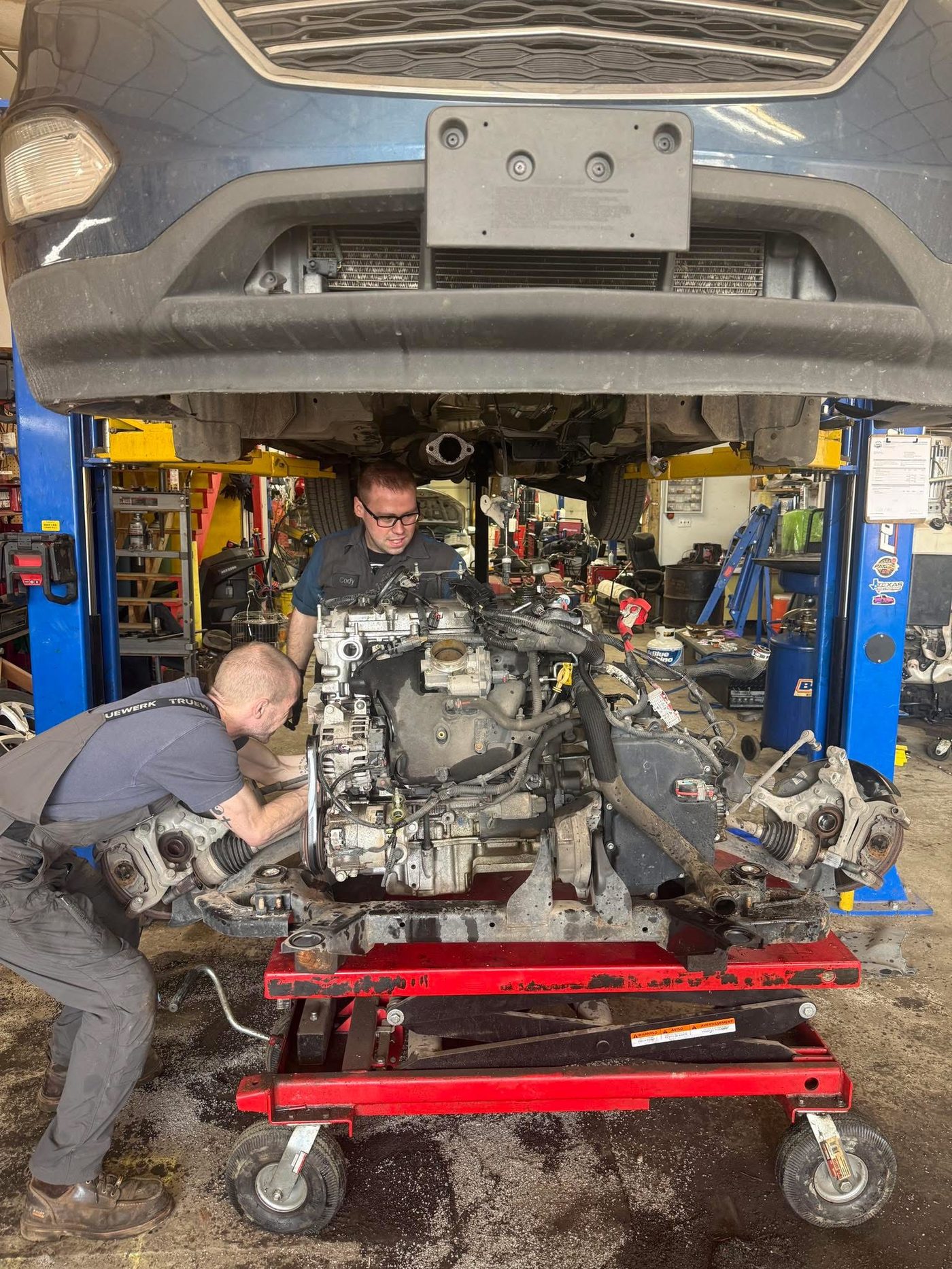 Neff's technicians installing an engine in the shop